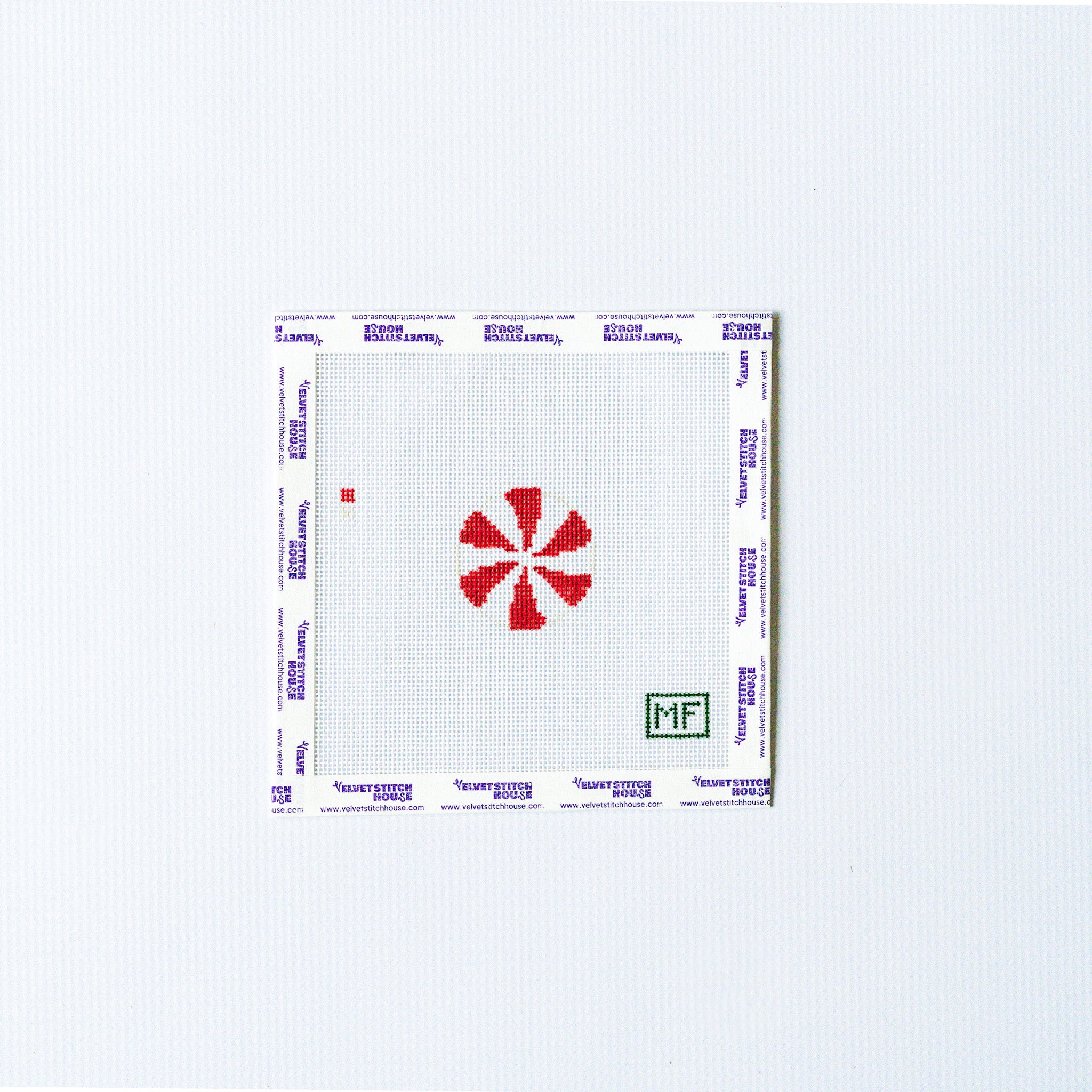 Needlepoint mini design with red and white round peppermint.
