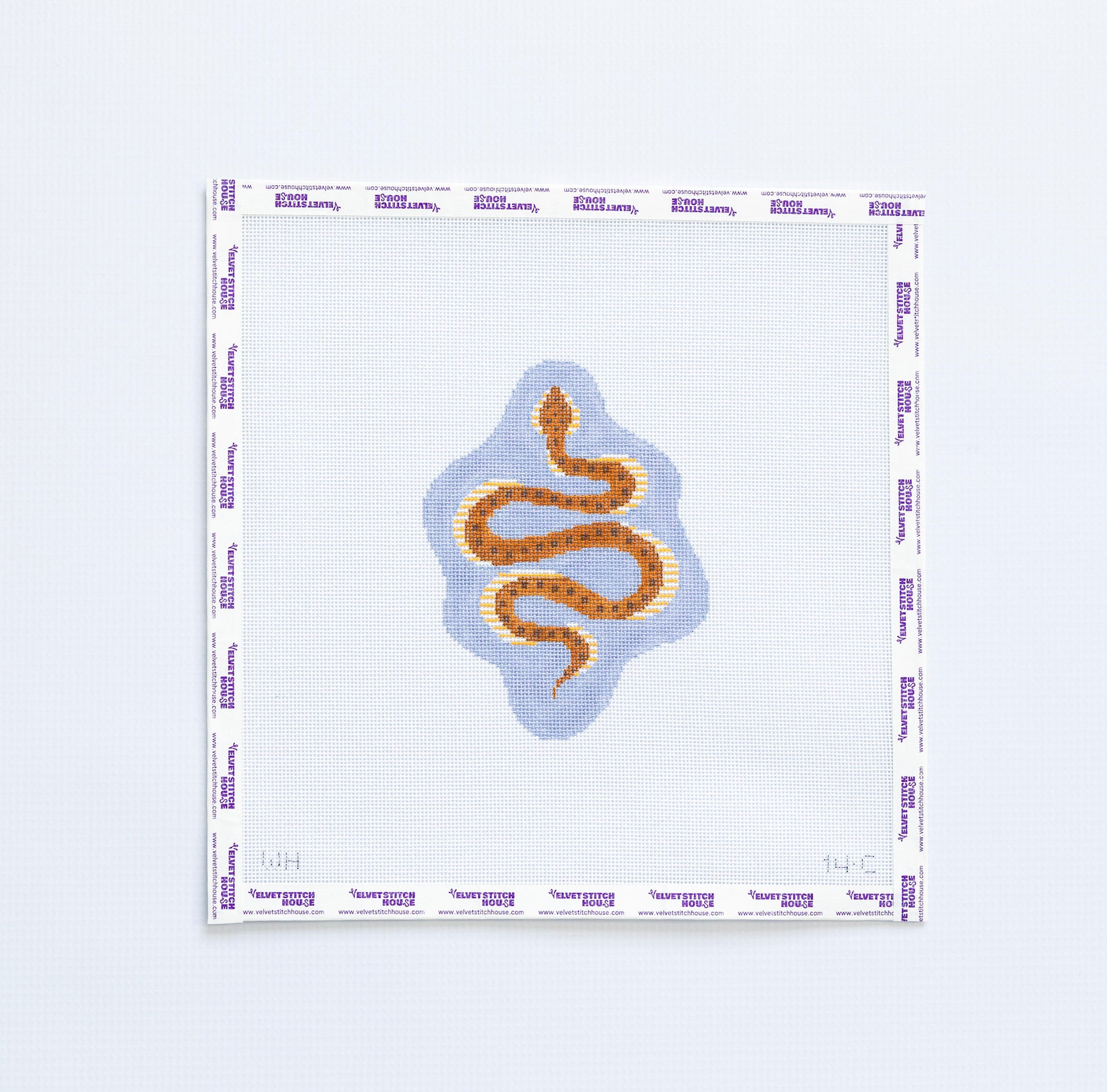 Needlepoint pattern with a brown snake design on a light blue  background