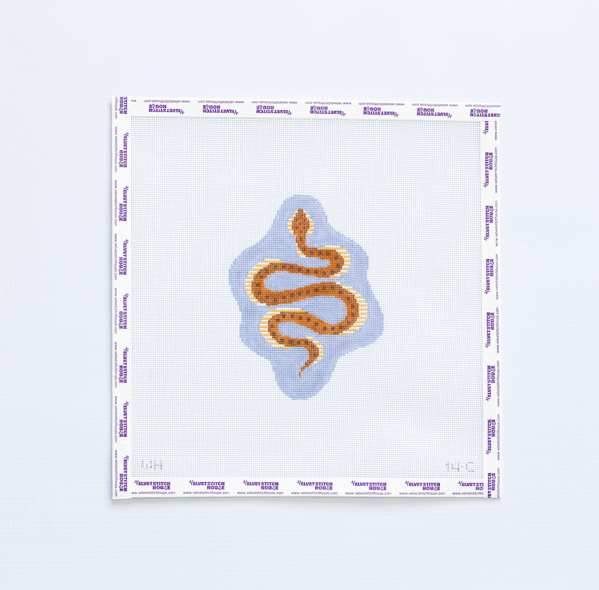 Needlepoint pattern with a brown snake design on a light blue  background
