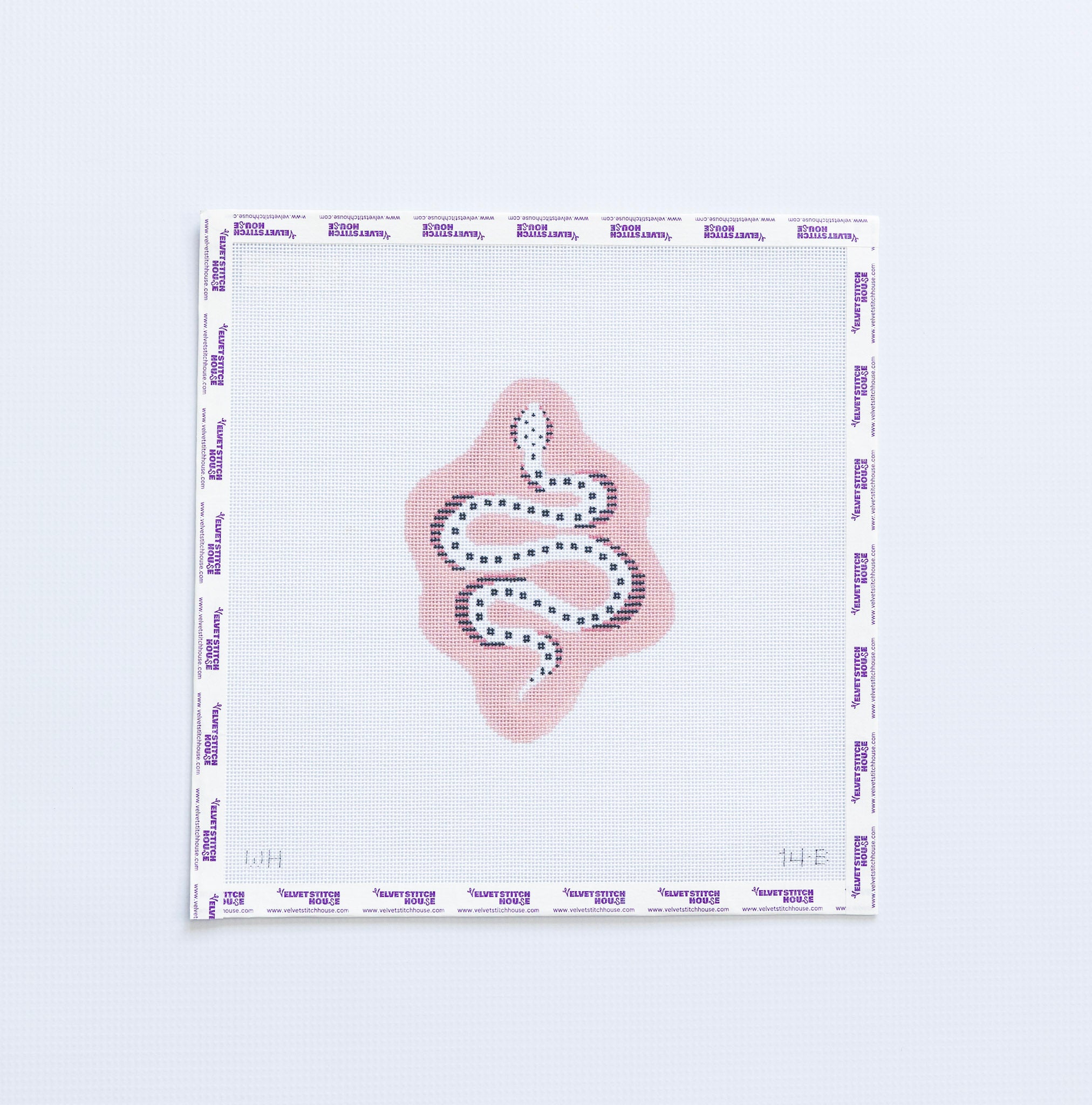 Needlepoint pattern of a white snack on a light pink background