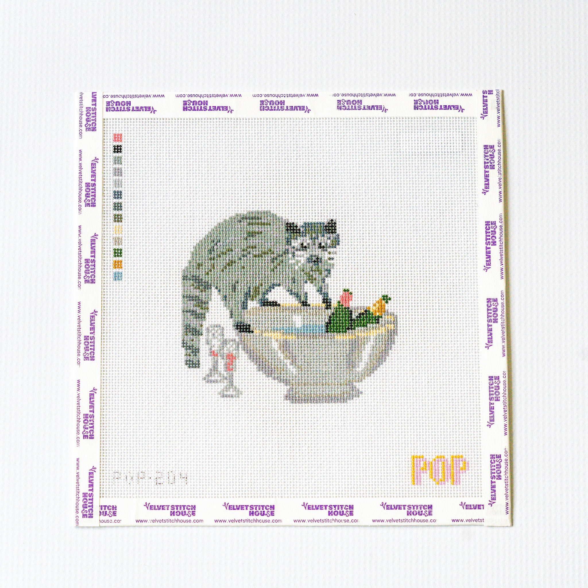 Needlepoint pattern with a raccoon in a bowl with champagne design on a white background