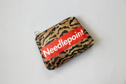 Leopard print pouch with 'Needlepoint' logo on red