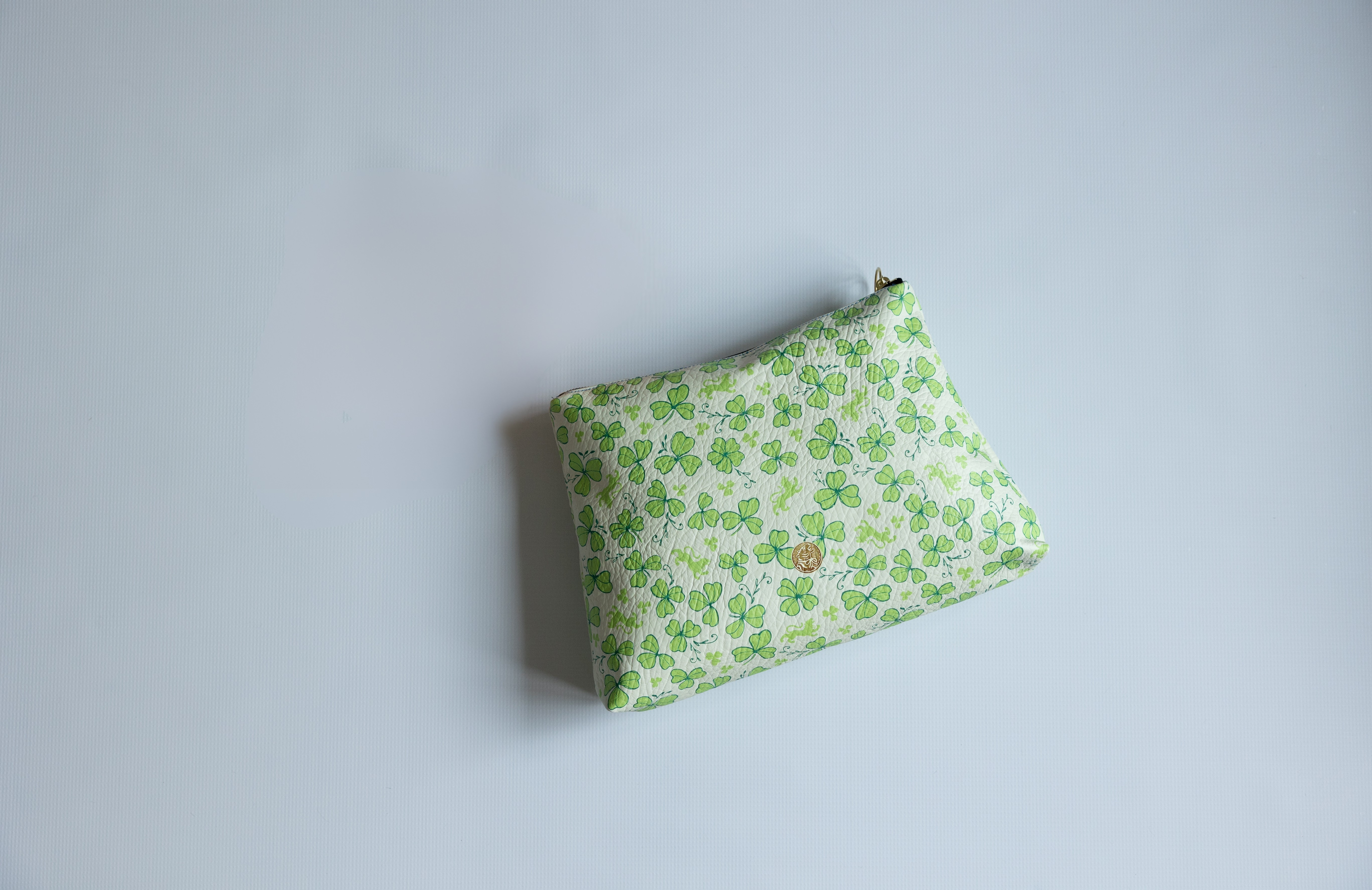 Green floral pouch on a light gray background