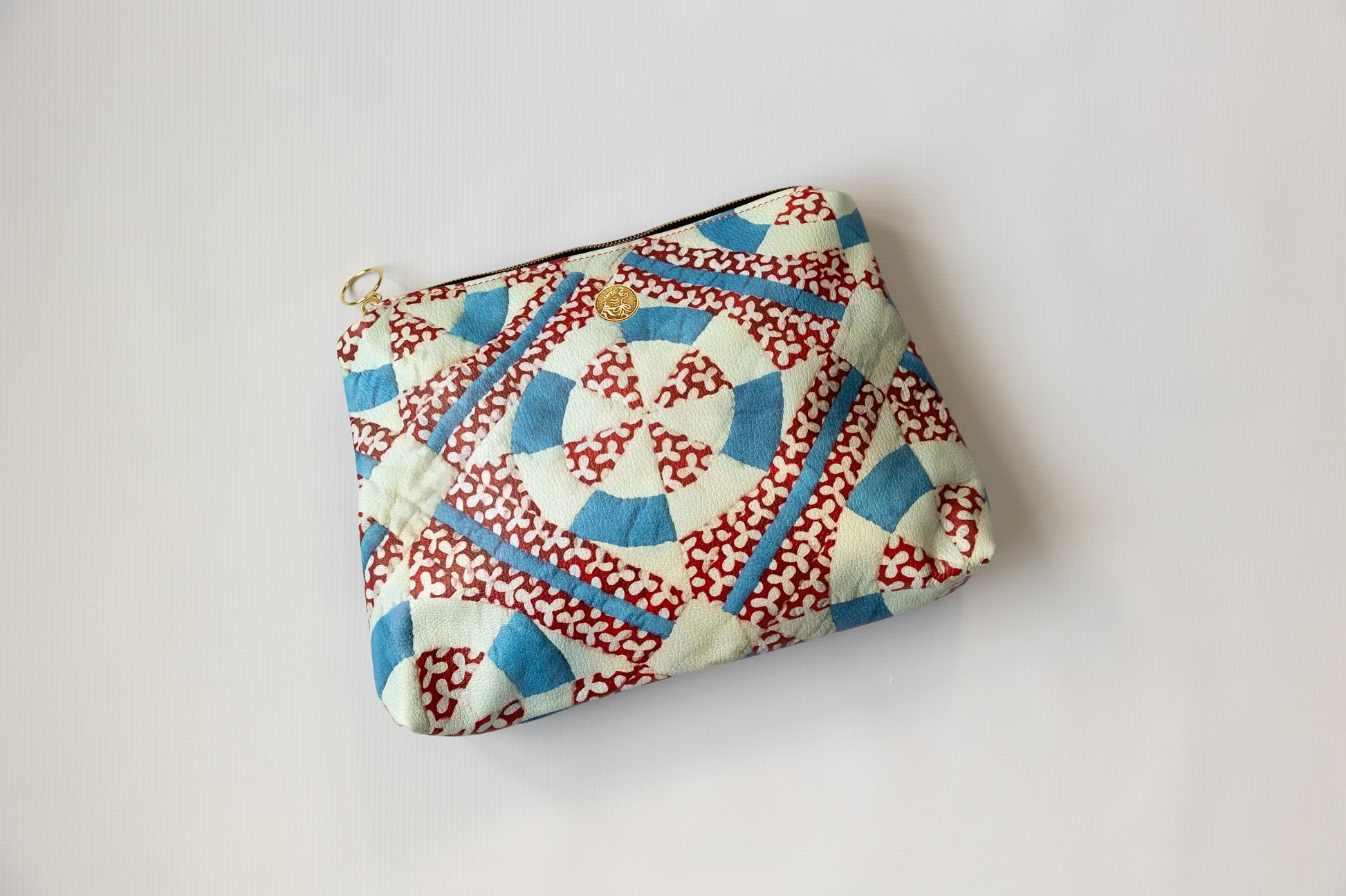 Fabric pouch with red and blue pattern on a white background