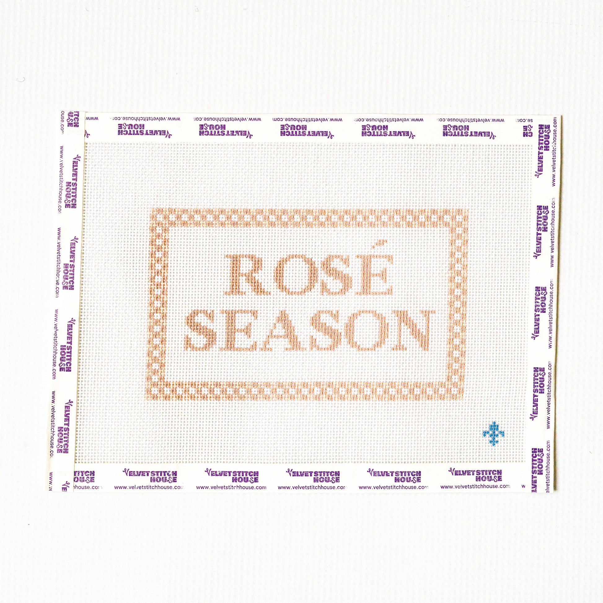 Needlepoint pattern with 'Rosé Season' text on a white background