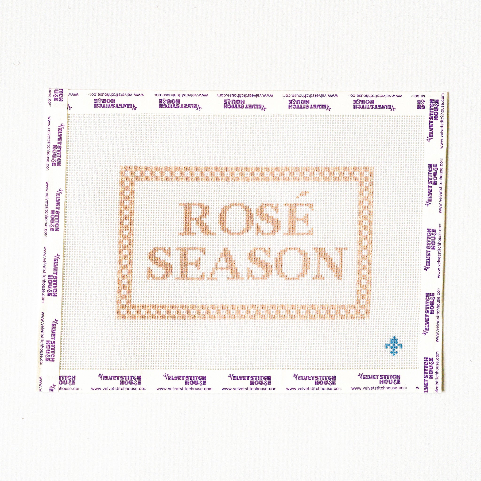 Needlepoint pattern with 'Rosé Season' text on a white background