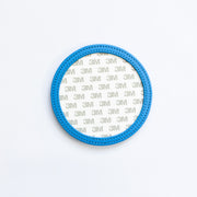 Blue circular coaster with 3M branding on a white background