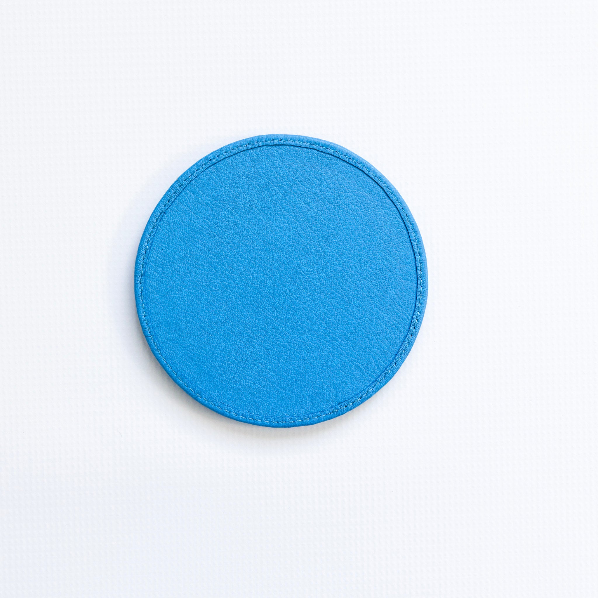 Blue circular patch on a white background