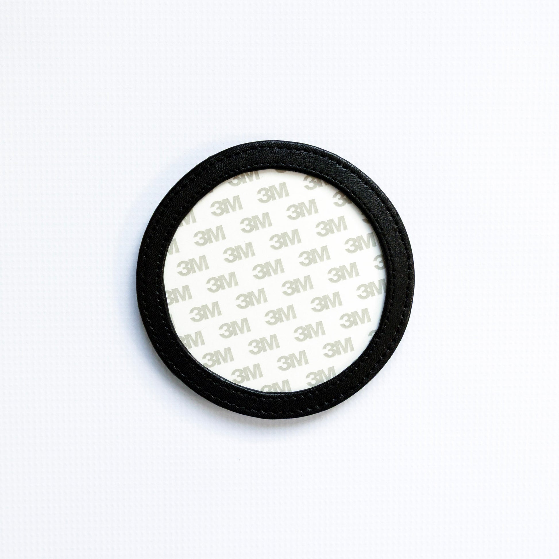 Round coaster with 3M adhesive on a white background