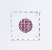 Needlepoint pattern with a purple circle and gold design on a white background