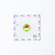 Needlepoint mini pattern with red adn white santa hat on a green background
