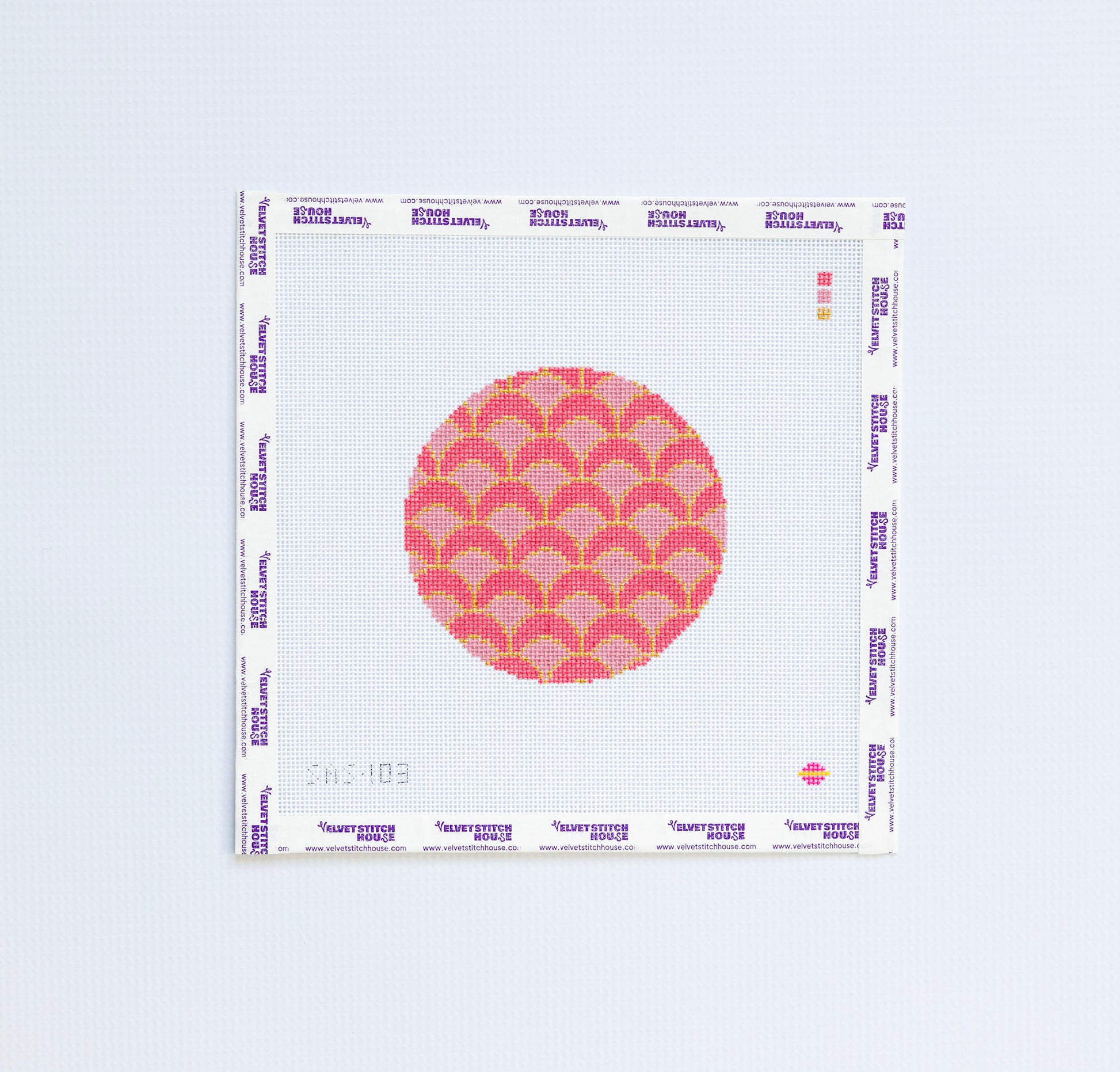 Needlepoint pattern with pink and red geometric circular design.