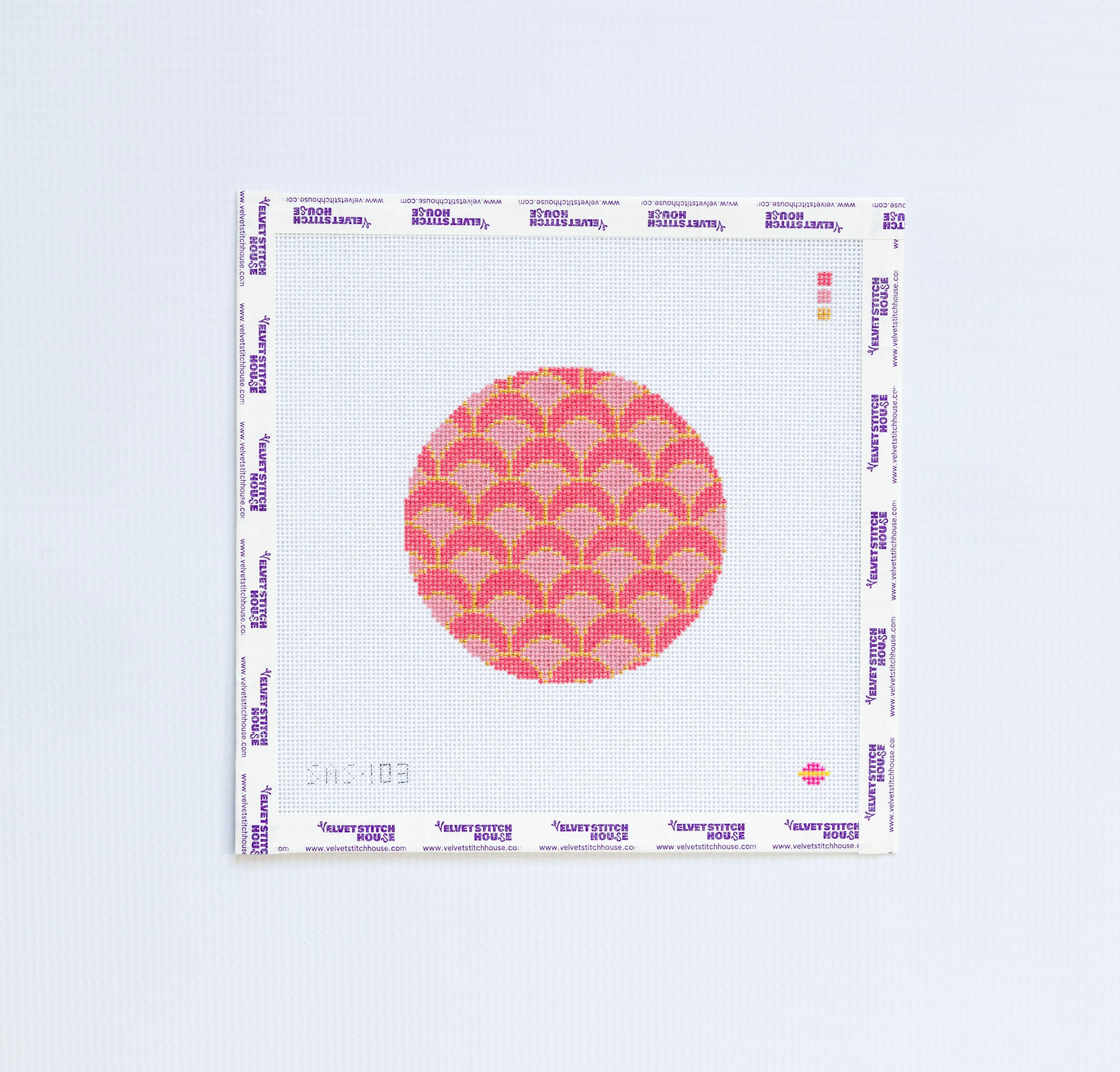 Needlepoint pattern with pink and red geometric circular design.