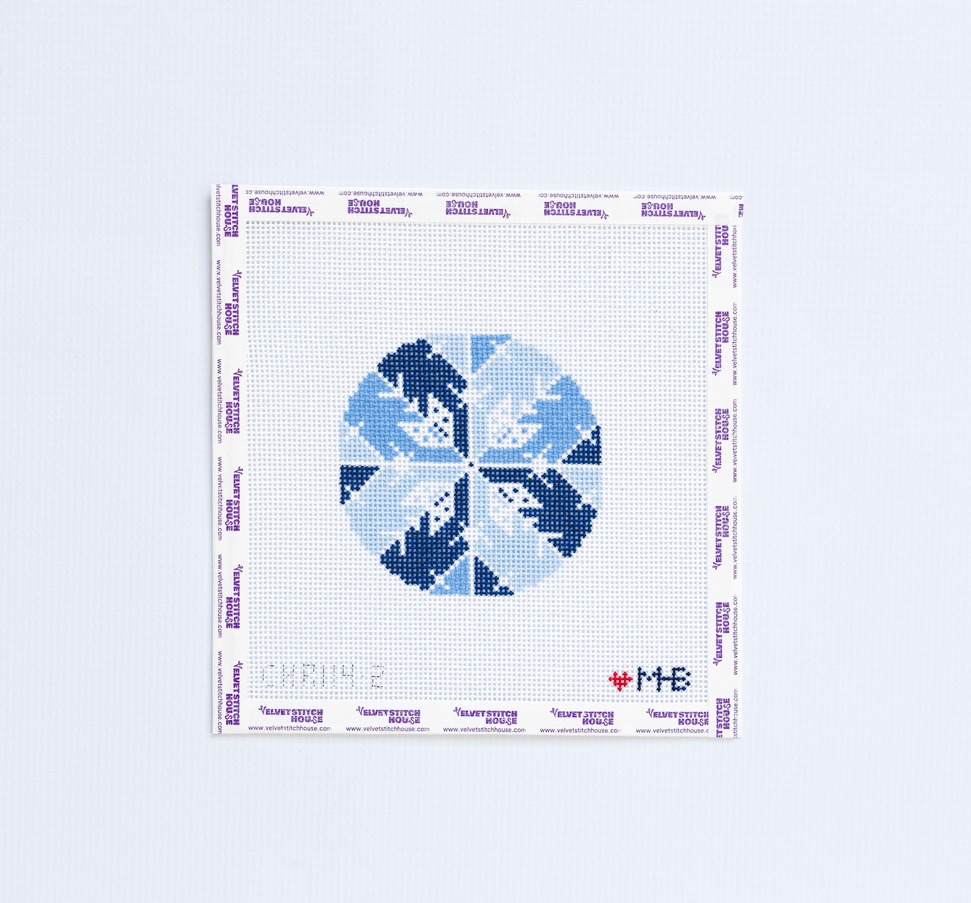 Needlepoint pattern round with dark and light blue snowflakes