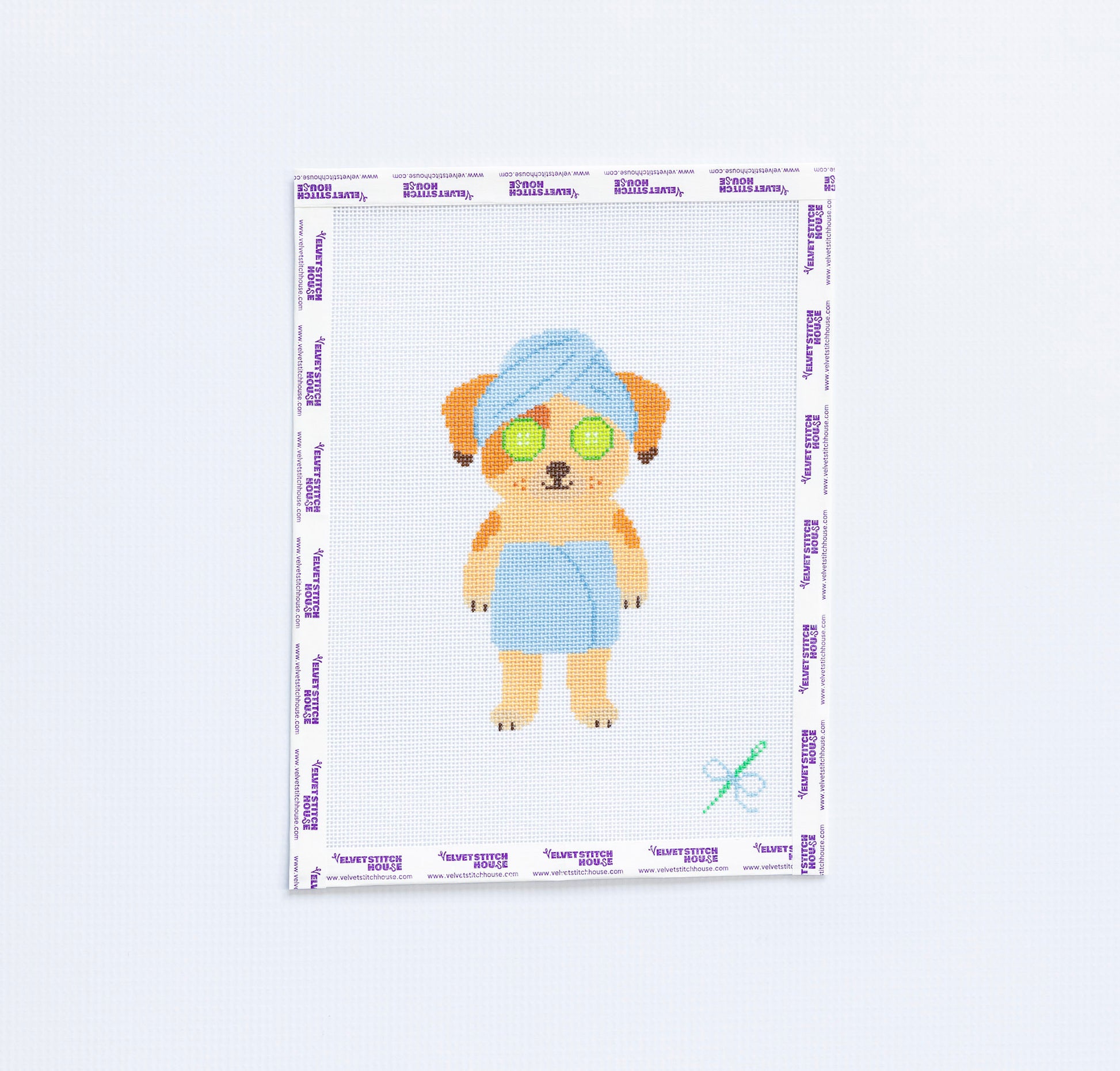 Needlepoint canvas of brown down wearing towel 