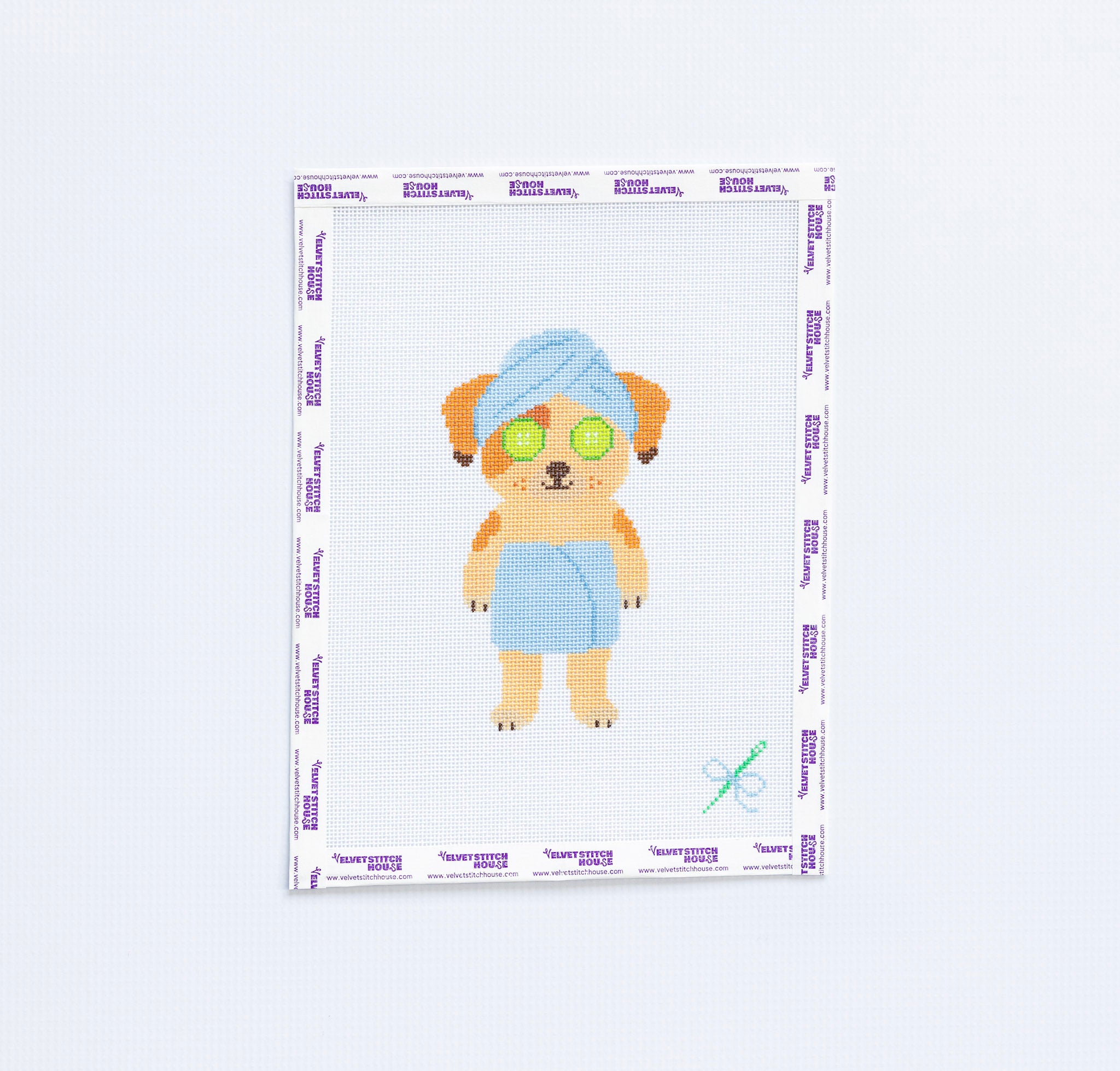 Needlepoint canvas of brown down wearing towel 
