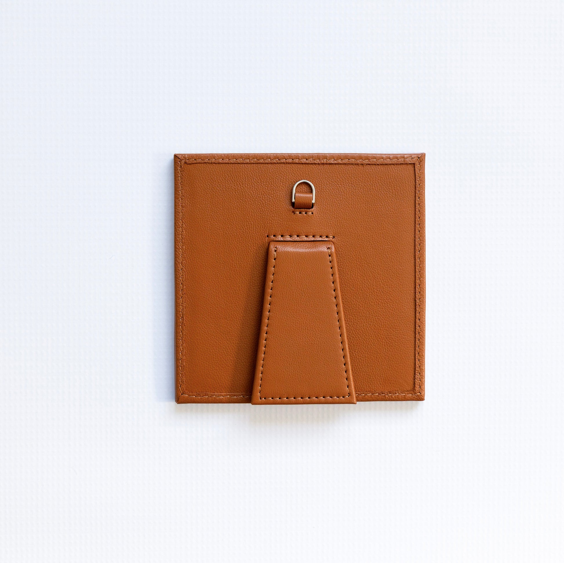 Small square self finishing frame with a brown border on a white background