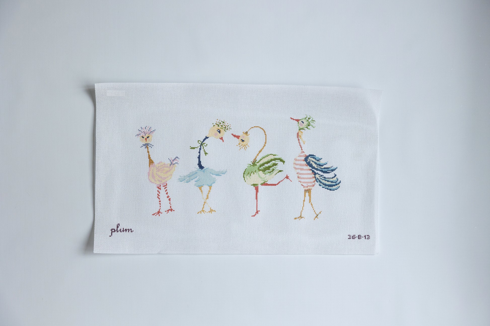 Needlepoint design with Cartoon-style flamingos dancing on a white background