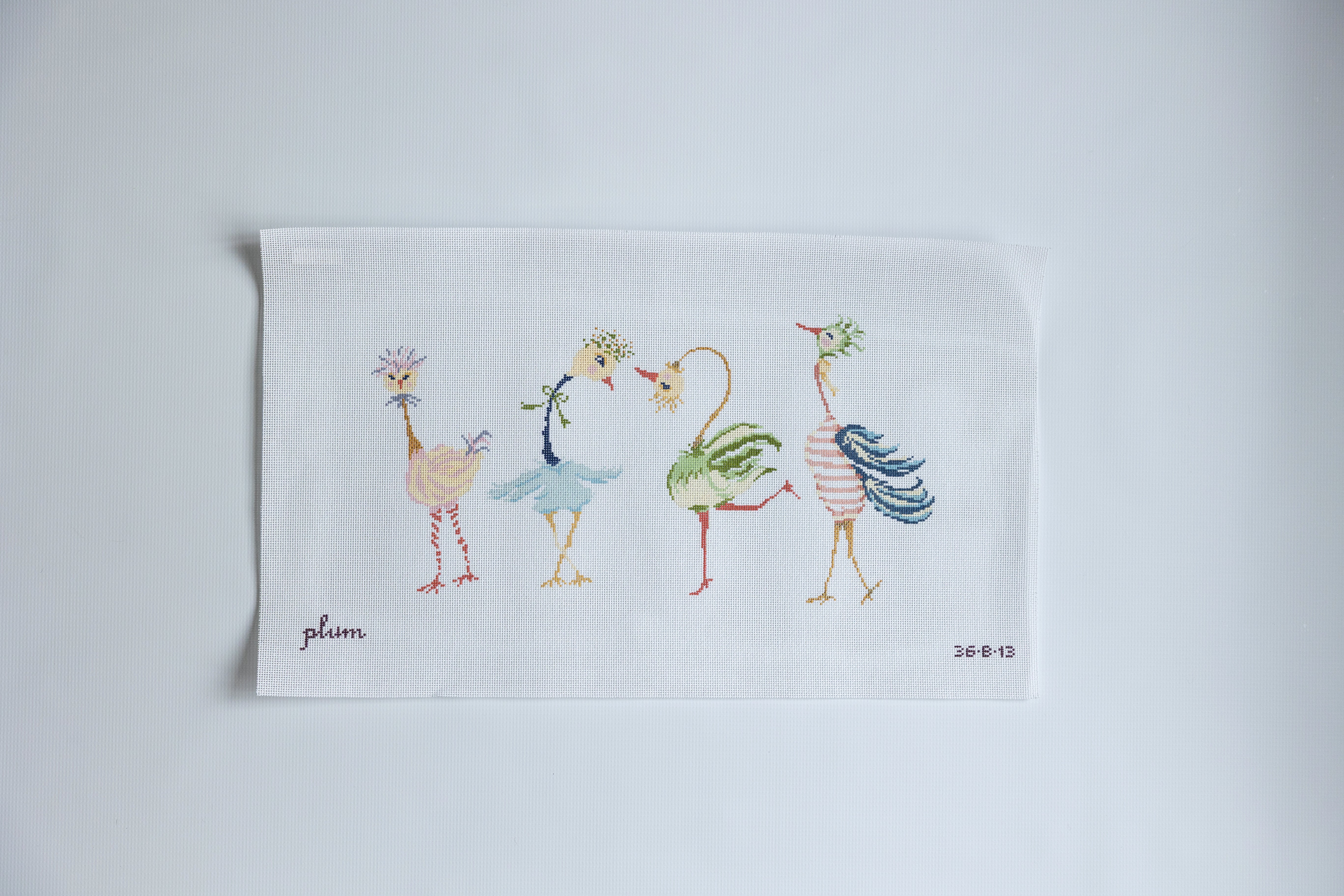 Needlepoint design with Cartoon-style flamingos dancing on a white background