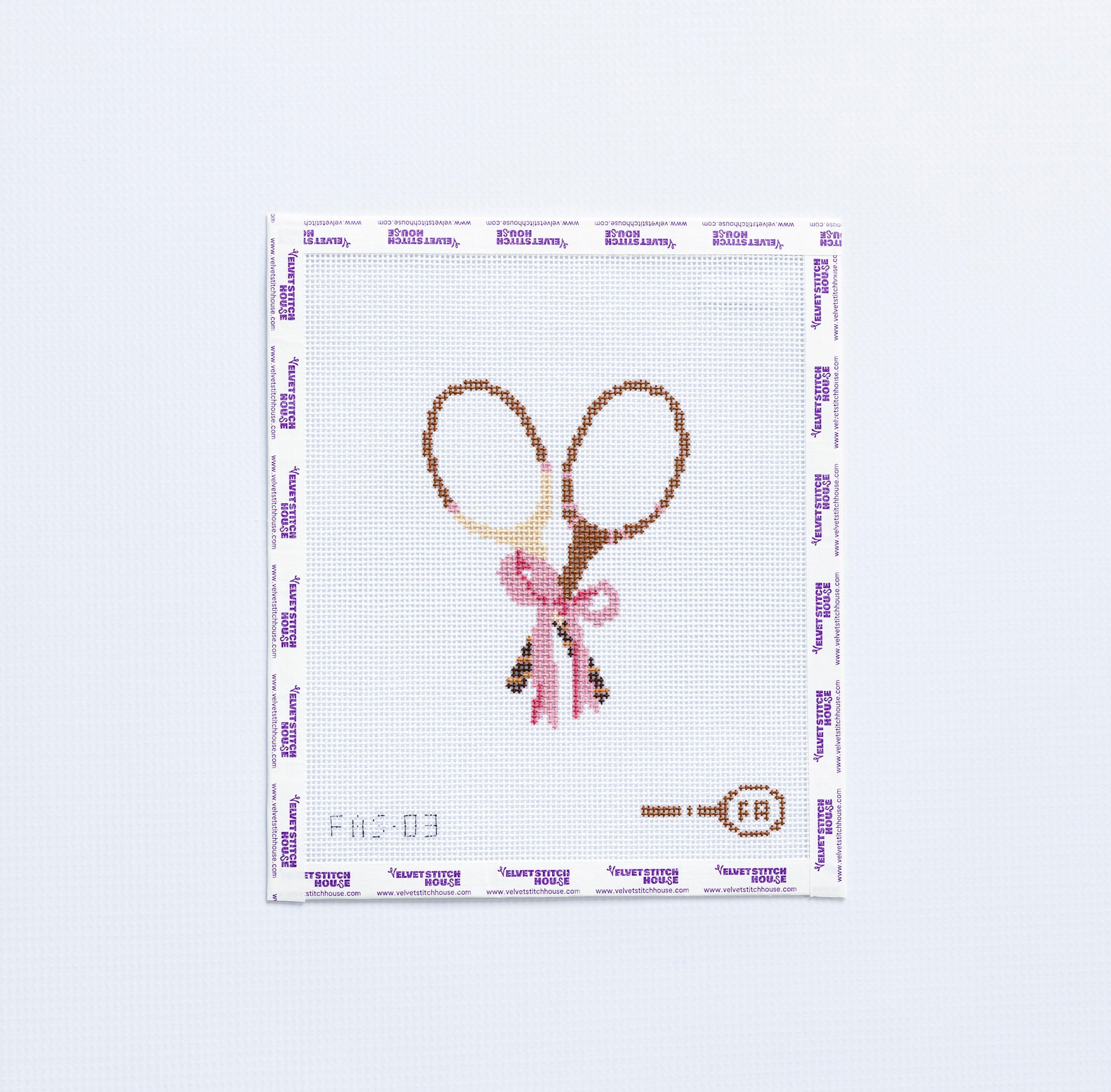 Needlepoint pattern with two vintage tennis rackets tied with a pink bow.
