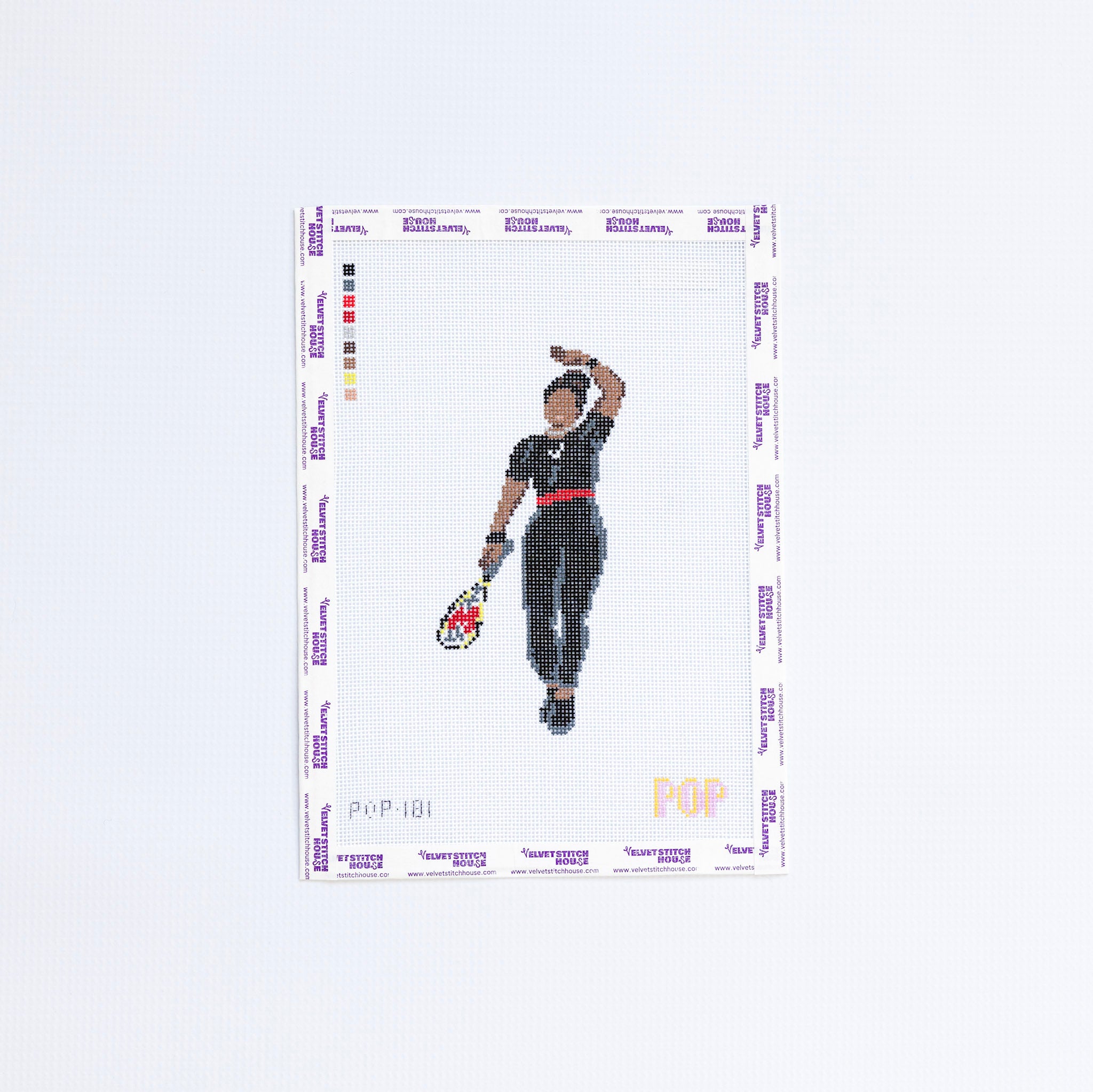 Needlepoint pattern of a tennis player holding a racket on a white background