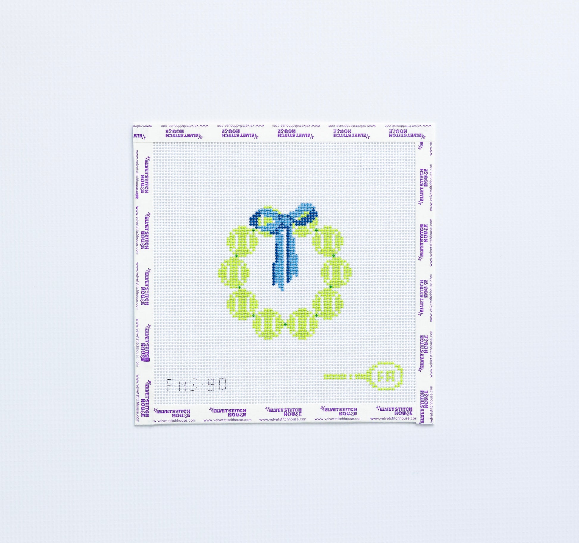 Needlepoint pattern round with yellow tennis balls and blue bow on a white background.