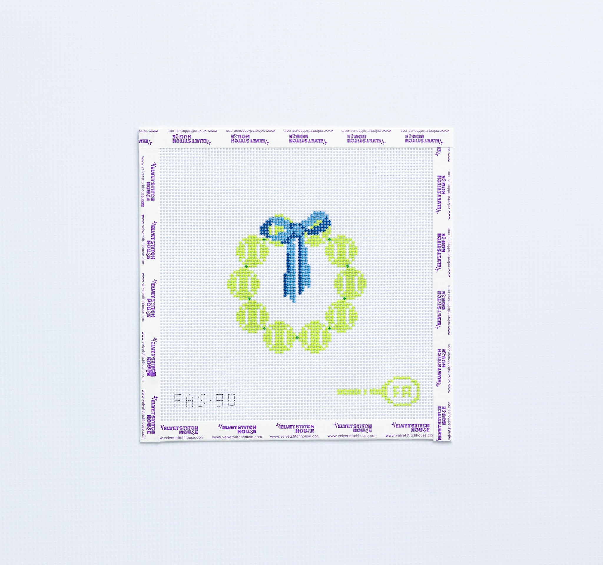 Needlepoint pattern round with yellow tennis balls and blue bow on a white background.