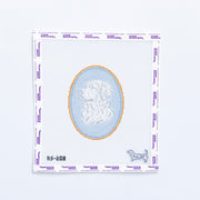 Needlepoint round pattern with a design of a golden retreiver on a light blue background