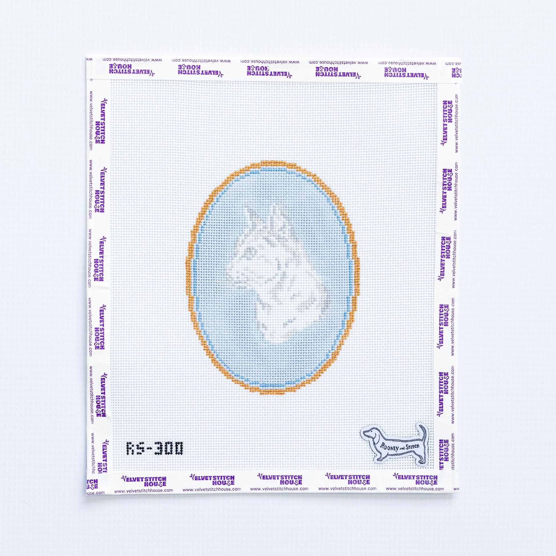 Needlepoint pattern with a short haired cat design on a light blue oval background.