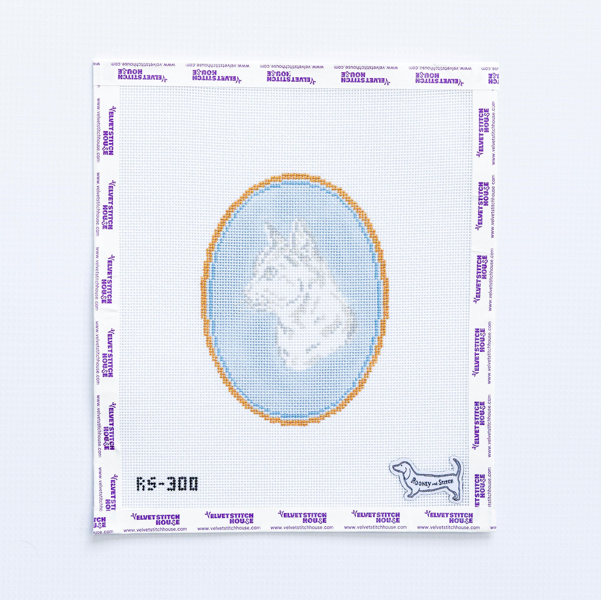 Needlepoint pattern with a short haired cat design on a light blue oval background.