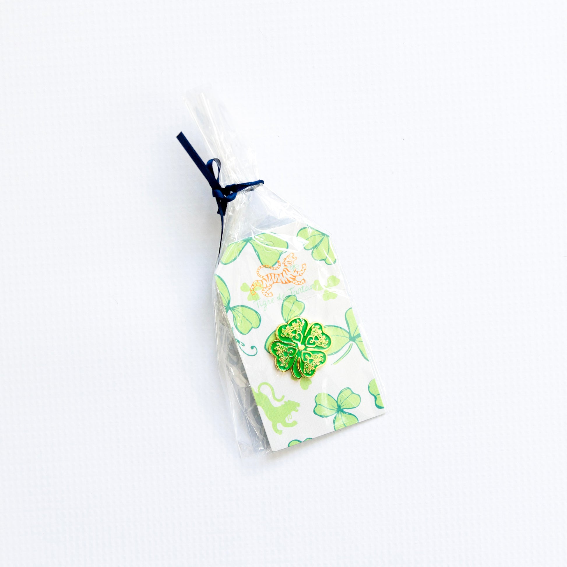 Small white pouch with green floral design needleminder magnet on a white background