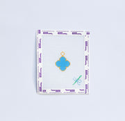 Needlepoint pattern with blue van cleef charm on white background