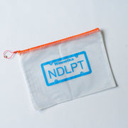 Clear zipper bag with orange zipepr and blue NDLPT and Winnetka text on designed license plate