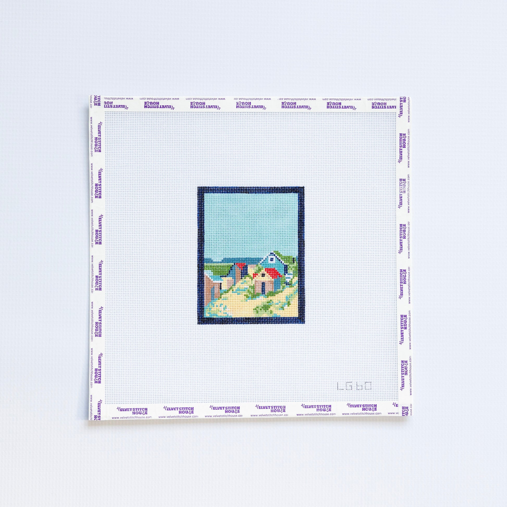 Needlepoint pattern of a coastal scene on a light blue background