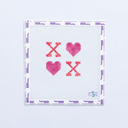 Needlepoint pattern with hearts in pink and red text with 'XO' on a white fabric background