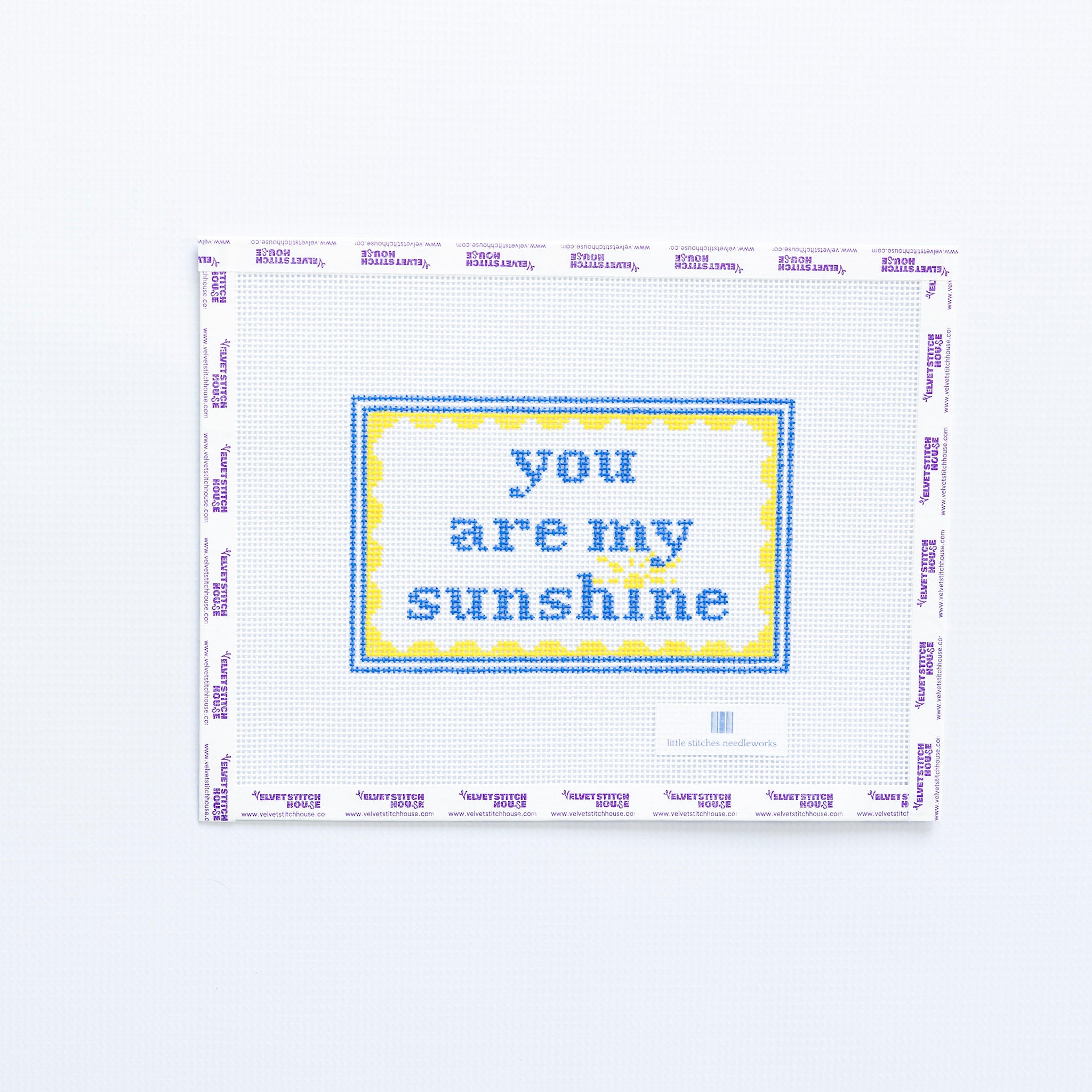 Needlepoint design with 'you are my sunshine' in blue text with a yellow scallop frame on a white background