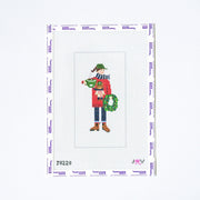 Needlepoint pattern with a person holding a wreath on a white background