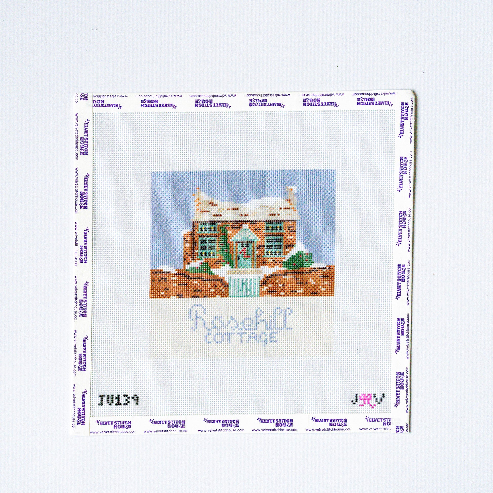 Needlepoint design of a house with 'Rosehill Cottage' text on a white background
