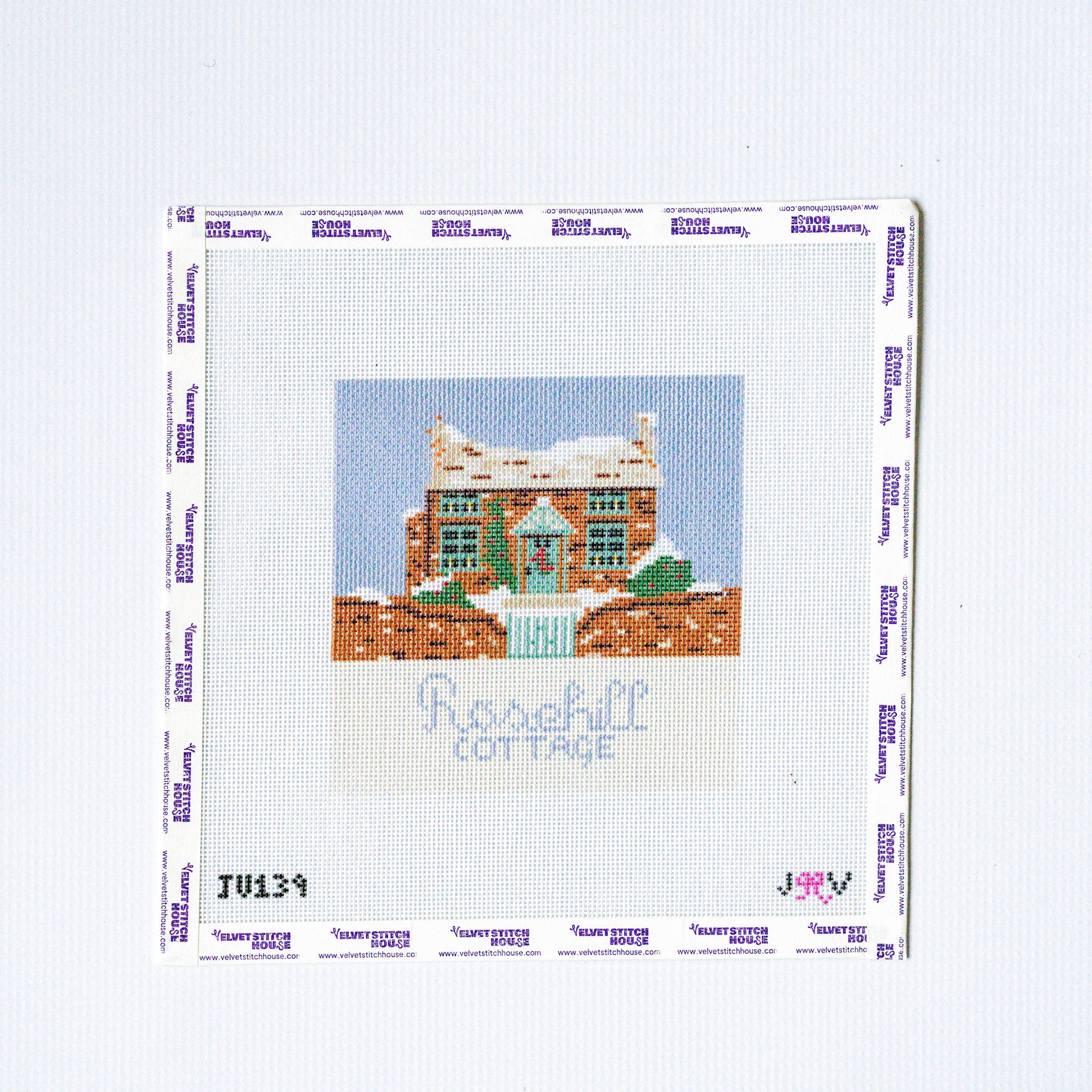 Needlepoint design of a house with 'Rosehill Cottage' text on a white background